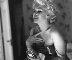 Marilyn Monroe putting on perfume