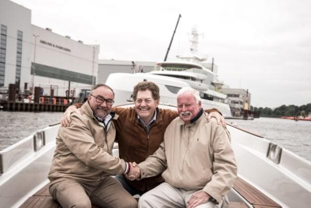 Hans Schaedla, Andrew Winch of Winch Design, and Captain Ray Shore are all smiles in front of Excellence in Lemwerder