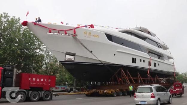 The superyacht was transported through the city centre to reach the sea