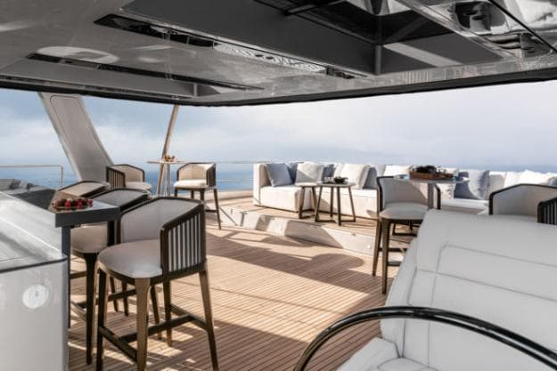 The flybridge has a karaoke bar, cocktail tables and oversized lounging sofa