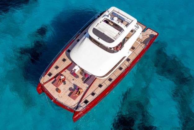 The red-hulled Lagoon Sixty 7 powercat features in REVIEWS; Photo: Nicolas Claris