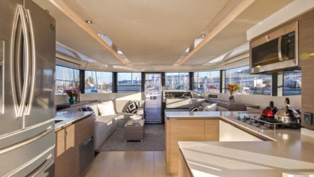 The enormous fridge is on your left as you enter the interior; the foredeck door is straight ahead, connecting the length of the yacht