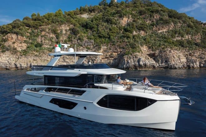 The foredeck has a C-shaped couch, table and adjustable sunpads, and can be shaded by an awning