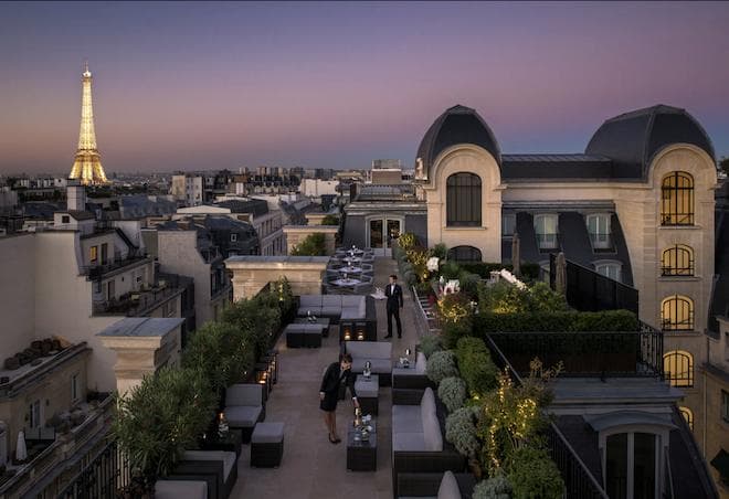 Rooftop Bar and Lounge in Paris overlooking the eiffel tower and set against the french city skyline and eiffel tower