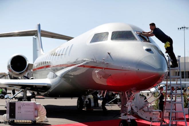 An aircraft detailer cleans the windshield of a VistaJet Global 7500 business jet in Nevada, U.S.
