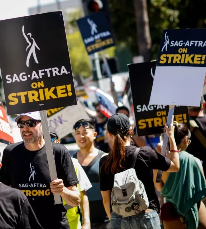 Members of SAG-AFTRA and the Writers Guild of America picket outside the Warner Bros. studio lot, in Burbank. (Jay L. Clendenin/Los Angeles Times)