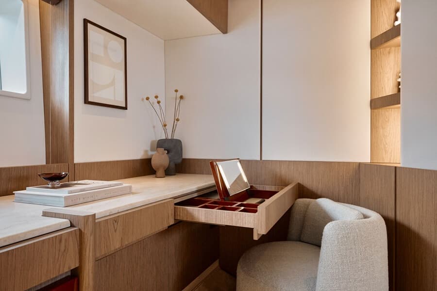 The master suite’s port cabinet includes an elegant vanity drawer