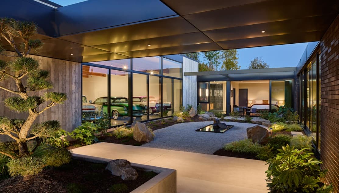 Lush gardens and an expansive car gallery wrap this charming residence. Image: futurehouseaward.com